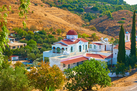 希腊Aegina岛的圣凯瑟琳修道院环绕着丘陵和花园环绕着希腊Aegina岛的圣凯瑟琳修道院背景