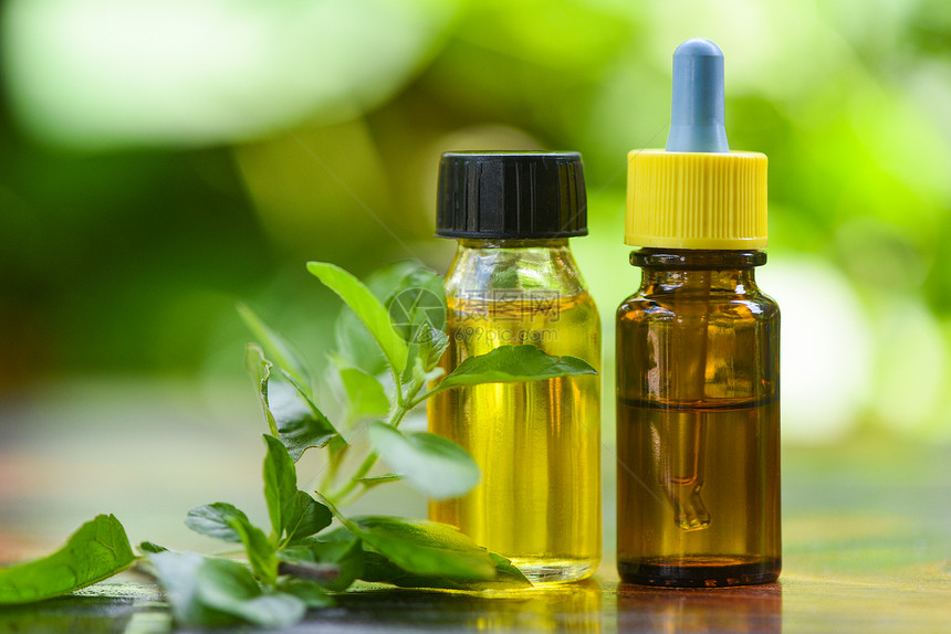 圣巴西尔基本油天然和绿底色背景阿洛玛治疗草药油瓶香兰水配有叶草药方包括和图片