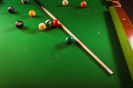 Billiard球和杆粘在绿色桌上池球游戏史努克和坚持在台桌上背景图片