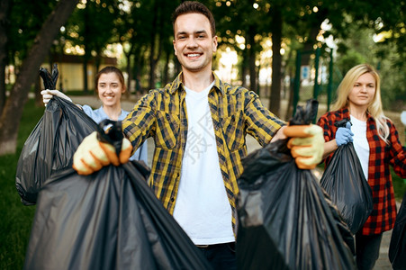 自愿者在公园里持有完整的塑料垃圾袋志愿工作男清洁森林生态恢复活方式垃圾收集和回生态护理环境清洁图片