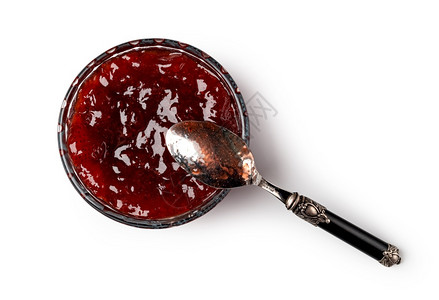 玻璃碗和红莓果酱汤匙图片