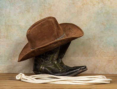 古老历史背景的典牛仔靴帽和套索图片