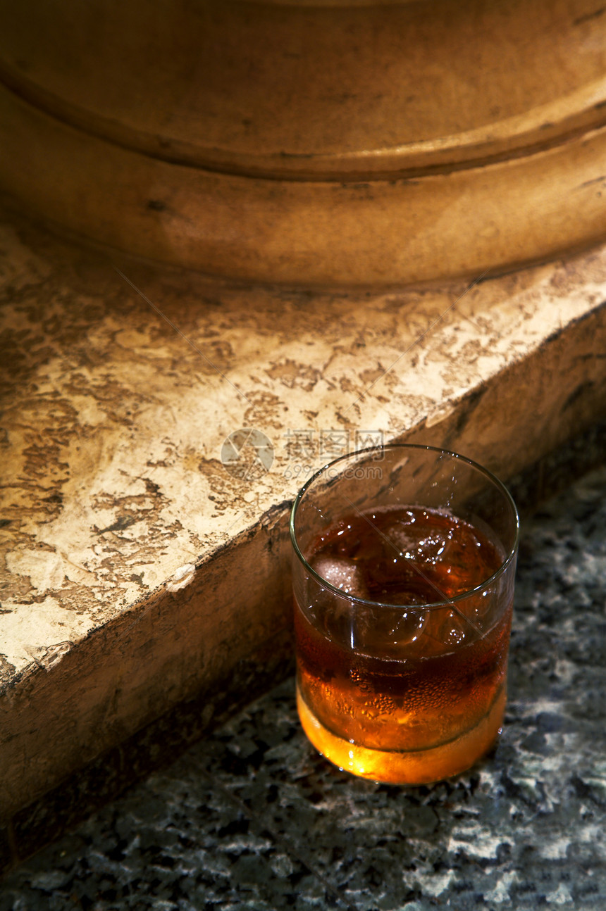 从威士忌到大理石地板的玻璃杯图片