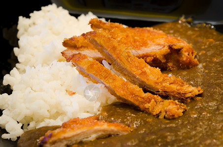 日本面包深炸猪肉切菜顿松配有蒸饭和咖喱酱背景图片