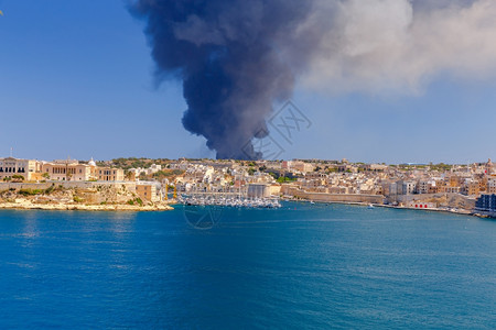 马耳他圣安特宁废物处理厂发生火灾由于圣安特宁回收厂发生火灾瓦莱塔市湾上空有巨大的黑烟柱背景图片