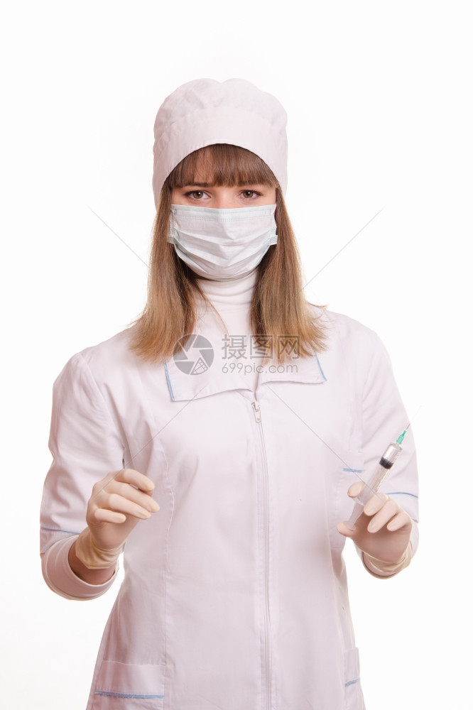 身穿白外套帽子手和面具拿着注射器和瓶子的医务工作者肖像图片