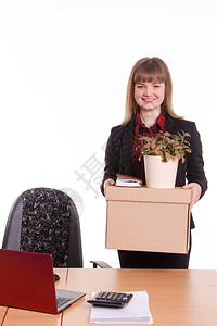 女孩在办公室接受一份工作办公室里拿着一个装东西的盒子女孩在办公室工作时通过女孩带了东西背景图片