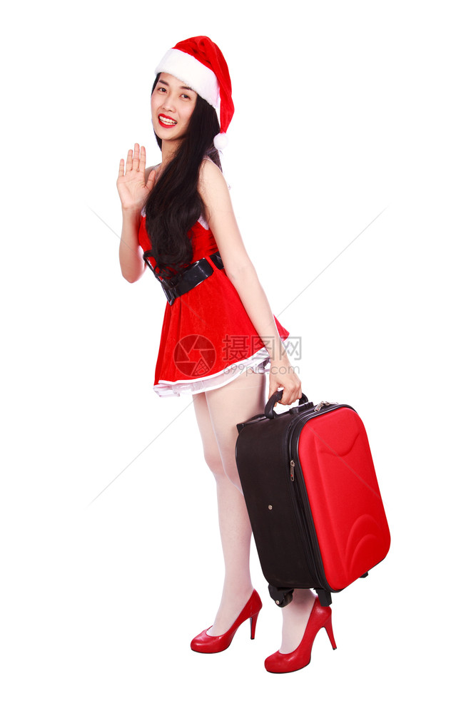 穿着圣诞老人服装的快乐女带着手提箱被白色背景隔离图片
