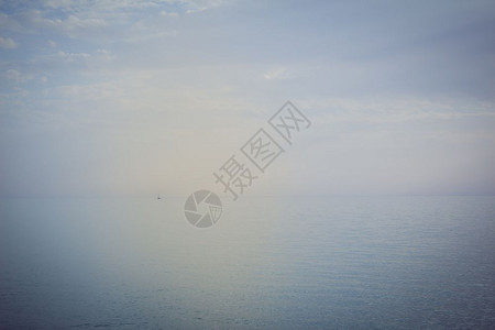 帆船在公海上航行船离地平线很远日落的颜色图片