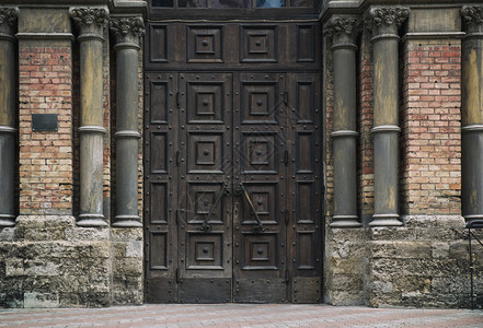 教堂的棕木门由砖头制成的墙壁图片