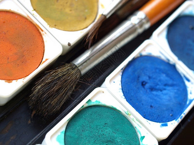 油漆工具配彩色调盘和刷子的油漆工具图片