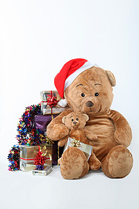 被圣诞礼物包围的泰迪熊背景图片