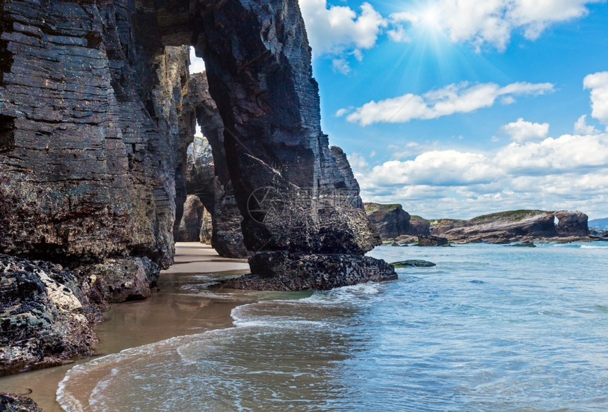 在低潮坎塔布里克海岸卢戈加利西亚班牙和阳光下大教堂海滩上的自然岩石拱门图片