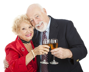 美丽的老夫妇用香槟杯敬酒白色的孤立无援庆祝高清图片素材