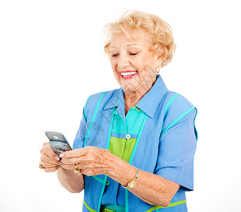 年长妇女喜欢在新手机上发短信孤立在白色上电子的高清图片素材
