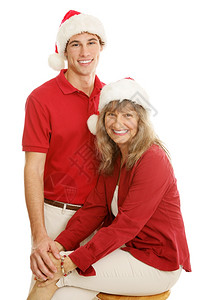 相当成熟的母亲和年轻大儿子假扮圣诞画像孤立在白色上图片