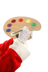 圣诞老人手握着油漆调色板和刷子图片