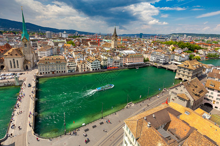 瑞士苏黎世天气晴朗的全景城市和Munsterbrucke桥的全景路堤高清图片素材