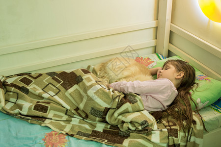 女孩和家猫睡在床上图片