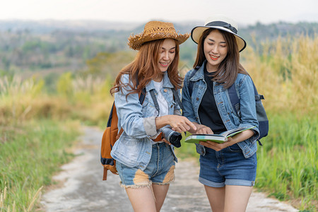 2名妇女旅行者在时地点图上搜索方向朋友高清图片素材