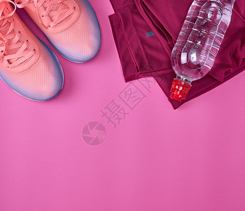 粉红背景的顶层风的水瓶和运动鞋水瓶图片