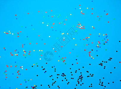 蓝色背景上散布的闪亮多色圆形彩蛋白生日节情人的喜庆背景图片