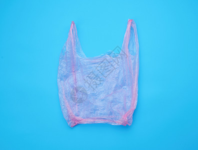 蓝色背景产品用空开放的塑料粉红色袋拒绝以保护环境的概念背景图片