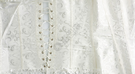 白色皮套件的碎片上面有彩色背视图新娘的衣服项图片