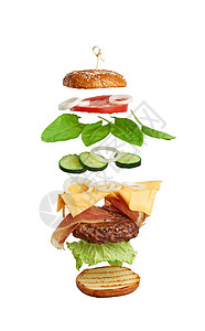 飘浮起司汉堡成份多汁的肉切菜达奶酪芝麻面包生菜白洋葱环番茄片黄瓜背景图片