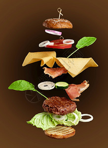 起司汉堡成份多汁肉菜干酪奶芝麻面包生菜白洋葱环番茄片棕色黄瓜图片