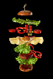 飞芝士汉堡成分黑底肉片芝麻士煎蛋番茄和绿生菜图片