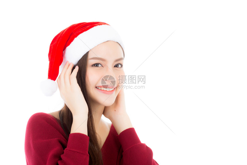 圣诞帽年轻的亚洲女肖像孩带着微笑快乐的与世隔绝在白色背景的Xmas和新年概念图片