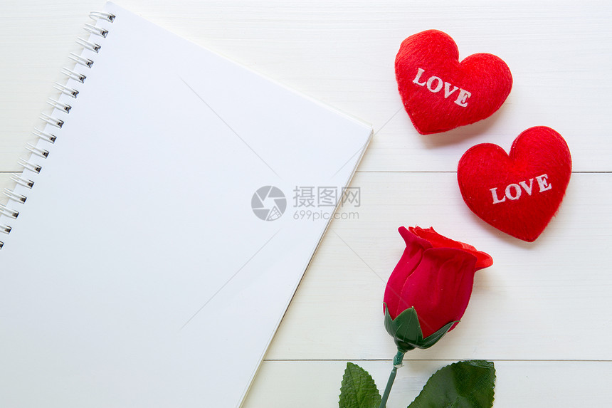 红玫瑰花笔记本和心脏形状木制桌上有复空间2月14日爱图片