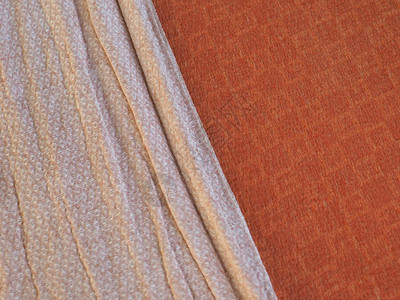 橙色和白色的床毯织物纹理可用作背景橙色和白色织物纹理背景图片