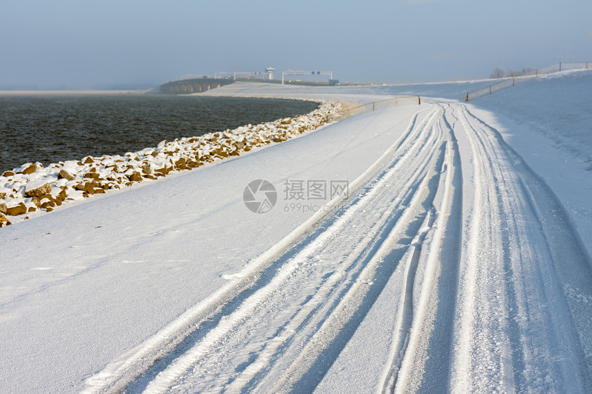 荷兰冬季有雪堤和轨图片