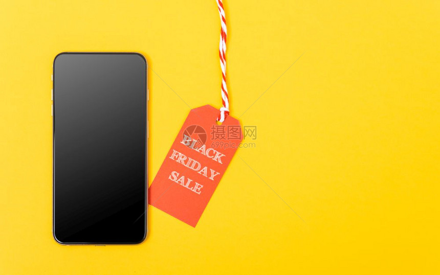 网上购物黑星期五销售红标签和黄色背景的智能手机空白屏幕图片