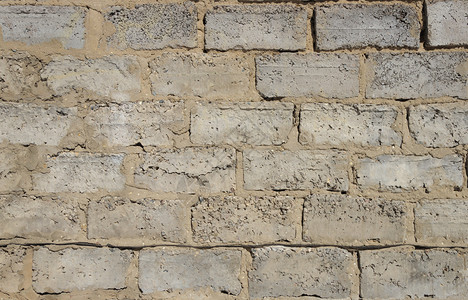 肮脏的砖砌灰混凝土块墙上紧靠的灰水泥砖墙壁城市的图片