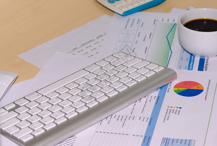 会计图表放在办公桌上的商务文件和键盘金融的图片