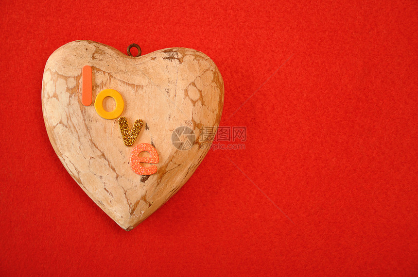 在红色背景下被孤立的木心上方爱这个词象征情人节庆典图片