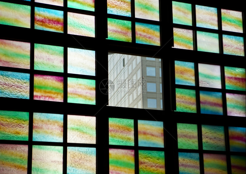 窗户建筑的由彩色玻璃窗环绕的一扇清晰窗口所显示的办公大楼景象建造图片