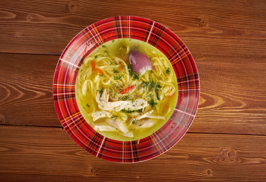 意大利面Tokmach泰坦河传统鸡汤和面粉碗黄色的盘子图片