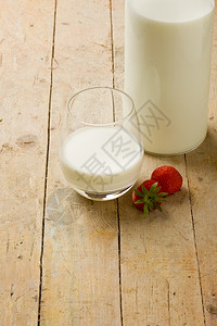 早晨产品在木制桌上加草莓的牛奶杯照片子图片