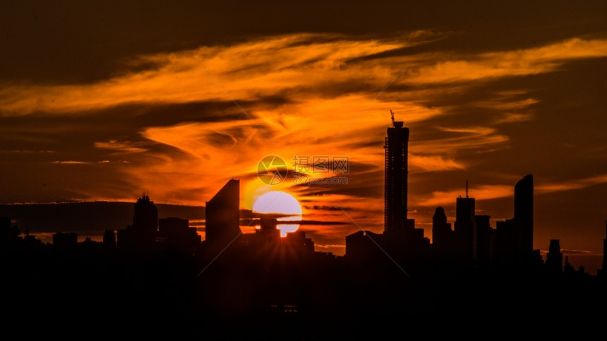 射线晚上自然在纽约的刮天机身后落下巨型美丽的太阳图片