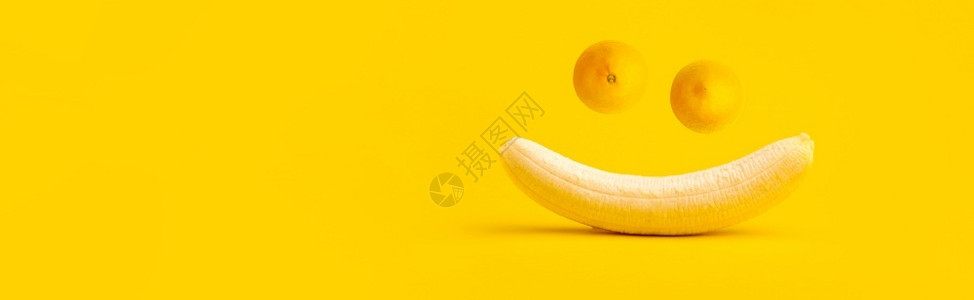 有趣的抗氧化剂黄色香蕉和两颗柠檬笑口罩夏天的概念饮食背景图片