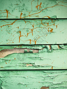 腐朽冒泡拉根华盛顿从西雅图一座腐烂建筑外墙上看到由喷泡和破碎的绿色涂料橙飞溅的颜料所创造的粗糙背景纹理设计图片