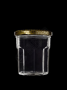 黑色背景的透明玻璃罐有封闭金色顶部贮存半透明58皮卡图片