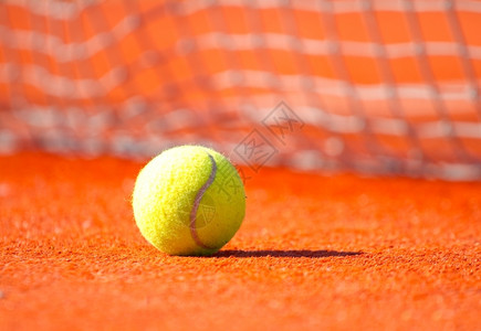 橙色球场上的黄网阳光比赛闲暇图片