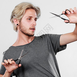 纹理美发师锋利的手持剪刀激情男理发师拿着剪刀显示工作具正常剪毛的人有头发的刀背景图片