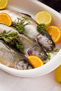 香菜地中海爵巴塔面包白碗中橘子和柠檬的鳟鱼配制照片图片