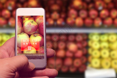 市场零售交货在超市背景中手持机与杂货店在线文本及模糊水果图片